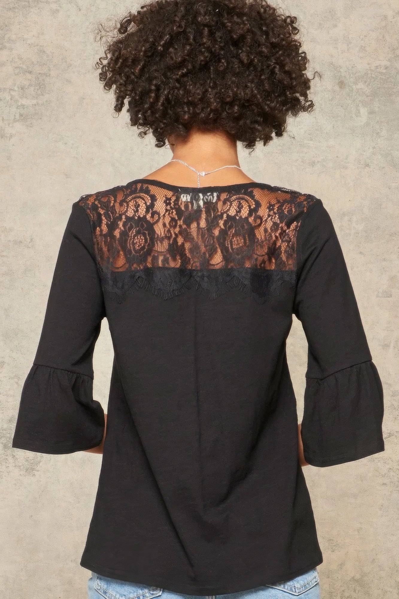 A Knit Top With Deep V Neckline And Yoke Design