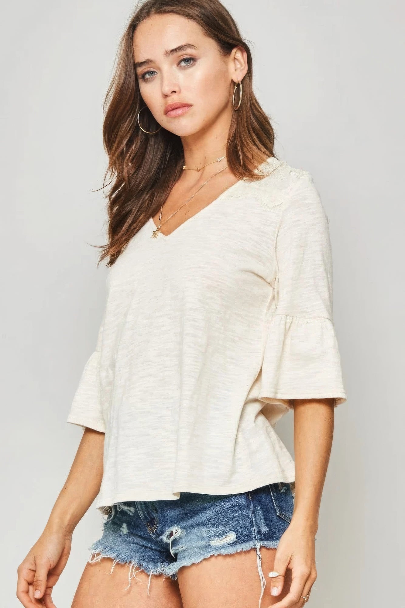 A Knit Top With Deep V Neckline And Yoke Design